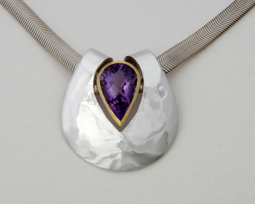 Silver form with Amethyst set in gold on a ribbon Snake chain